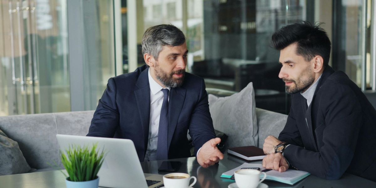 Two company directors in a tense boardroom discussion, illustrating early warning signs of a shareholder dispute
